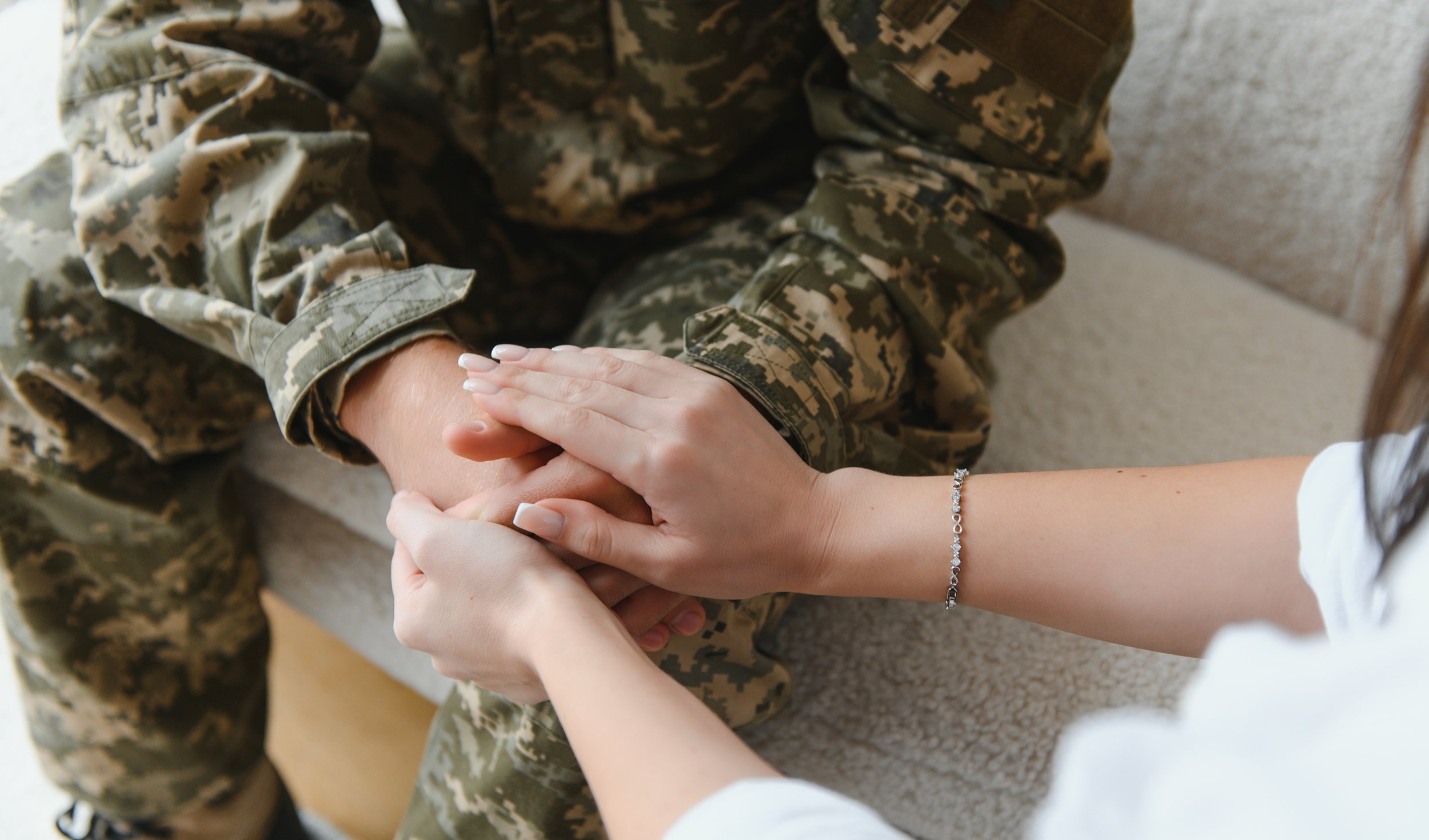 Soldier holding hands with a woman